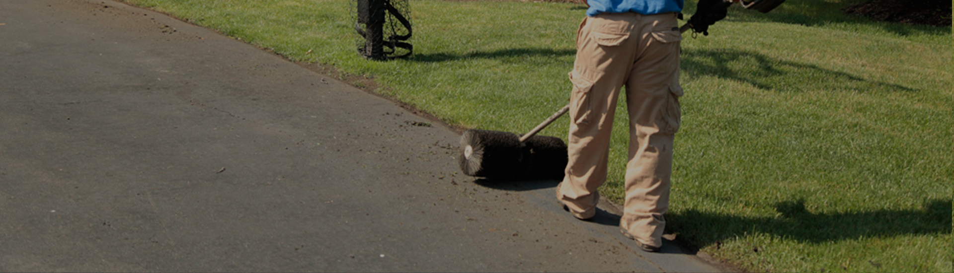 Sweep driveway with a power broom